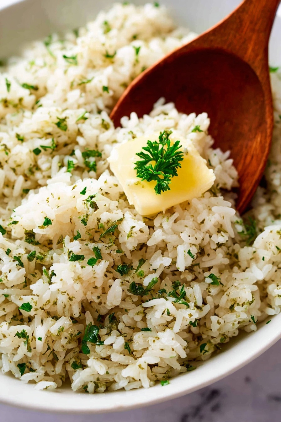 A large white oval plate holds a generous mound of cooked rice mixed with herbs and spices, giving the grains a light brown color with small green flecks throughout. The rice looks fluffy and soft, with a small pat of melting butter in the middle that is slightly shiny and creamy yellow. Fresh chopped green herbs are scattered over the top for decoration. A wooden spoon rests on the right edge of the plate, partially inserted under the rice. The scene is set on a white marbled surface with a blurred green and white cloth in the background. Photo taken with an iphone --ar 2:3 --v 7