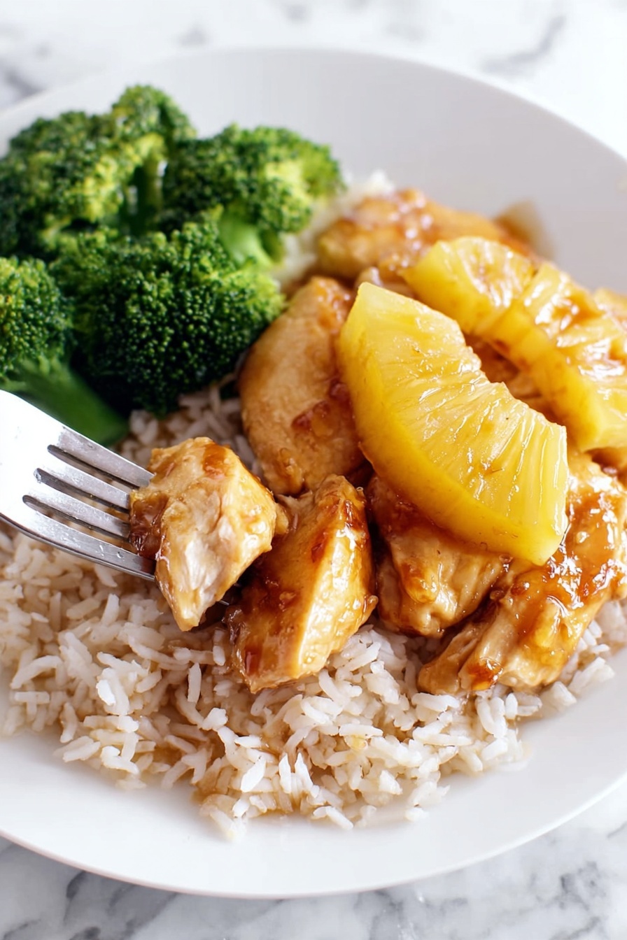 A white plate holds a meal with three main layers: a bed of white rice at the bottom that spreads across the plate, a layer of golden-brown cooked chicken topped with shiny, caramelized pineapple slices covered in a rich brown sauce sitting in the middle, and a bunch of bright green broccoli florets placed to one side of the plate. A silver fork, held by a woman's hand, lifts a piece of chicken and pineapple from the rice, showing the juicy texture of the chicken and the glossy sauce dripping slightly. The plate rests on a white marbled surface. photo taken with an iphone --ar 2:3 --v 7