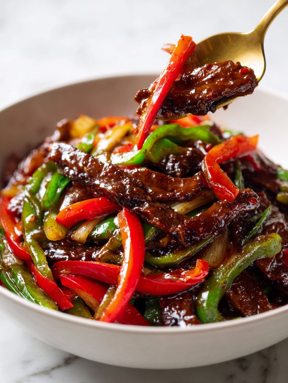 The dish shows dark brown, glossy slices of cooked beef mixed with bright red and green bell pepper strips. The beef pieces are irregular in shape and richly coated in a shiny sauce. The peppers are cut into long, thin strips, adding vibrant color contrast around and between the beef pieces. It is served in a white bowl set on a white marbled surface, and the whole image looks fresh and juicy with a close-up view to highlight texture and color variation. photo taken with an iphone --ar 2:3 --v 7