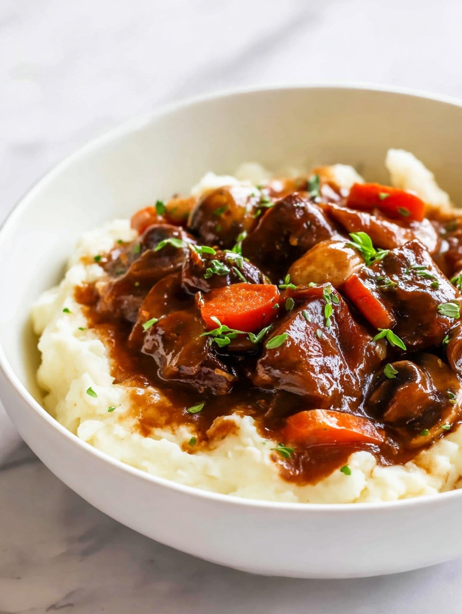 A white bowl filled with two main layers: the bottom layer is creamy, white mashed potatoes with a soft and smooth texture, and the top layer is a thick, rich brown beef stew with visible chunks of tender beef, sliced carrots, and mushrooms all coated in a glossy gravy. Small green herb pieces are scattered lightly on top, adding a touch of color. The bowl sits on a white marbled surface with bright natural lighting highlighting the dish's textures and colors. Photo taken with an iphone --ar 2:3 --v 7