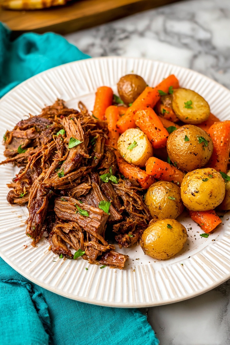 A white plate with a layer of shredded brown slow-cooked beef covering most of the left side, showing stringy texture and garnished with small green herb pieces. On the right side, a mix of whole and halved golden small potatoes alongside bright orange carrots with a slightly roasted look, all sprinkled with herbs. The plate is on a white marbled surface, with a glimpse of a bread roll and a turquoise cloth in the background. photo taken with an iphone --ar 2:3 --v 7